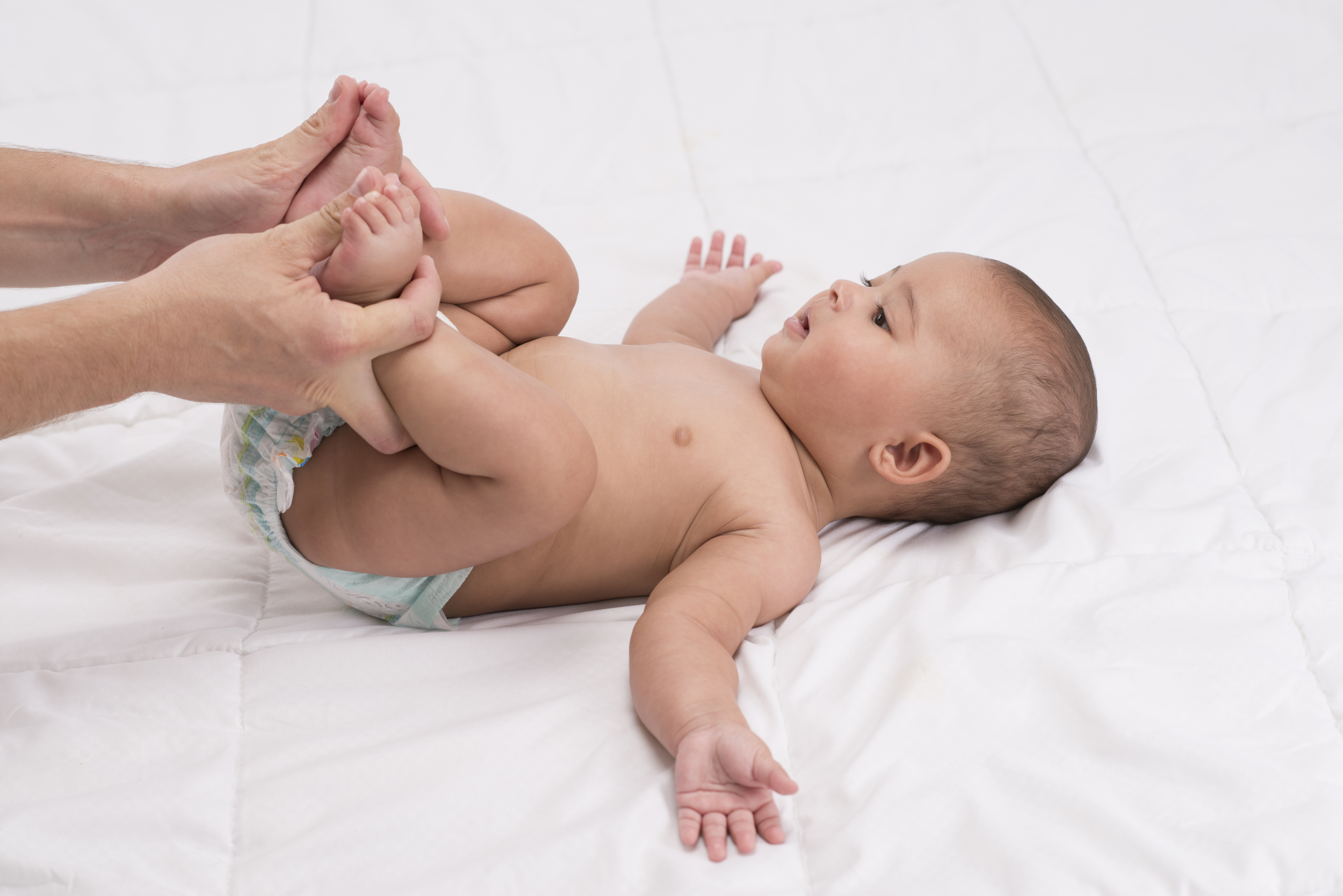 cyclic motion with baby's legs to soothe colicky baby